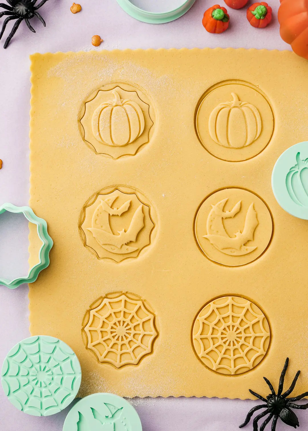 Demonstration of cookie stamps pressed on rolled out dough. The cookie stamps set also comes with a free ebook with recipes and helpful tips.