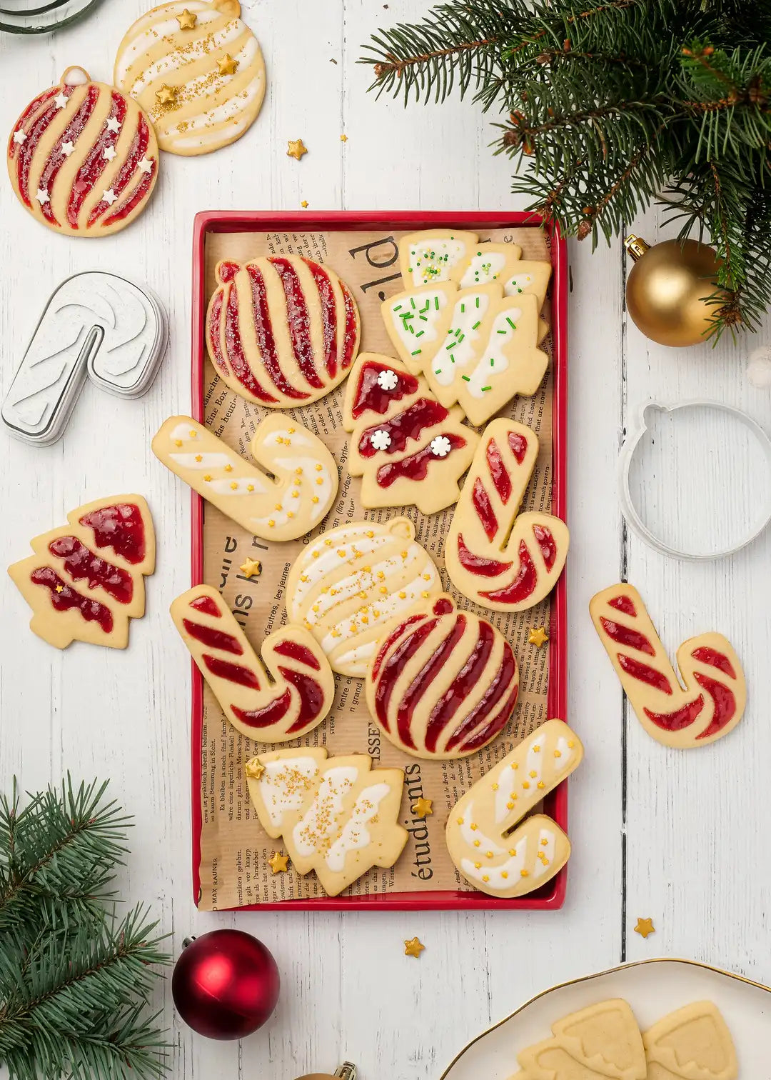Photo of cookies made with the stamps and cutters set. The cookies are bakedand then decorated with icing, red jam and festive sprinkles on top.