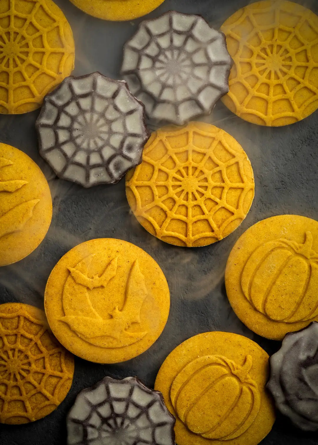 Close-up of baked cookies featuring the raised 3d embossed designs and level of detail that the cookie stamps create.