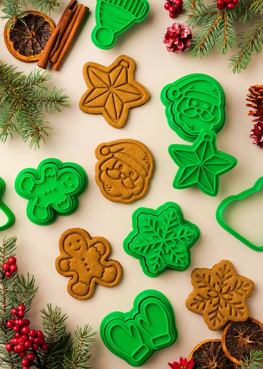 Christmas cookie cutters set, includes 6 stamps and 6 cutters with snowflake, Santa, gingerbread man, Christmas star, mittens and hat designs; photo of cookies made with the set and the cookie cutters