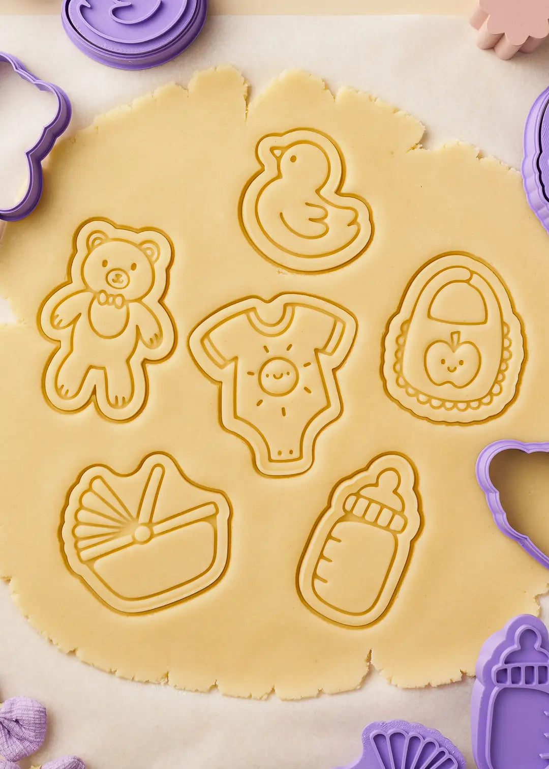 Close-up of freshly embossed cookie dough with baby-themed designs. The perfect way to create stunning cookies for baby showers, first birthdays, or gender reveal parties or just a gift for bakers.