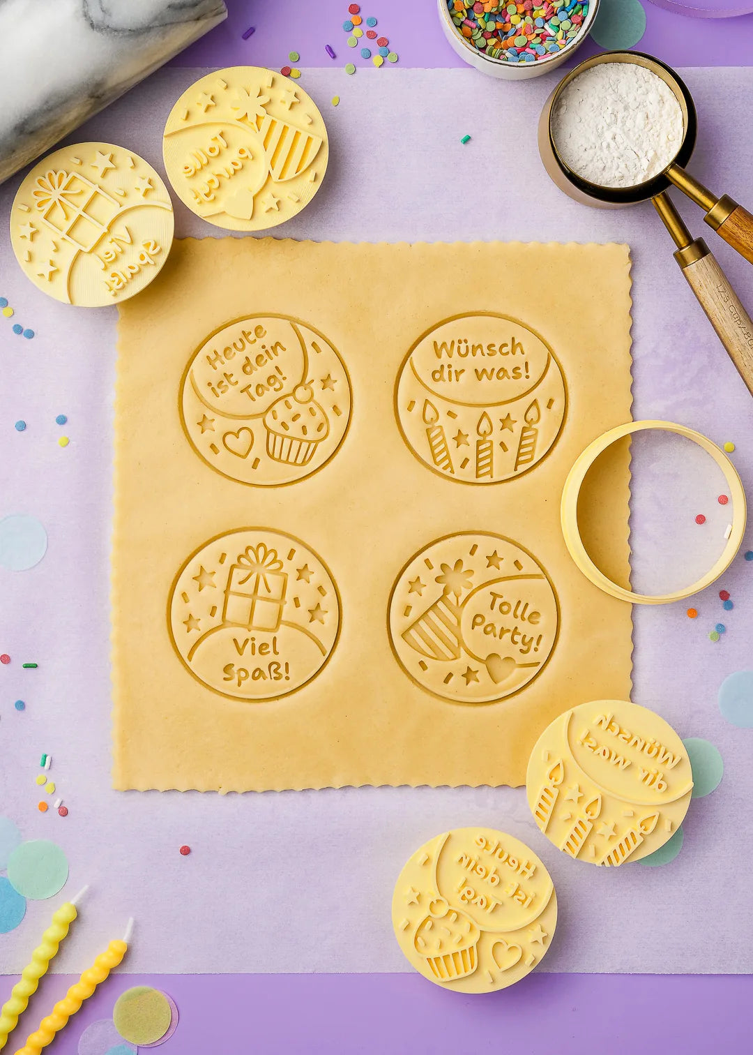 Cookie stamps pressing designs onto rolled-out dough, creating birthday-themed cookies with messages like "Heute ist dein Tag!", "Viel Spaß!" , "Tolle Party!" and "Wünsch dir was!"
with perfect detail.