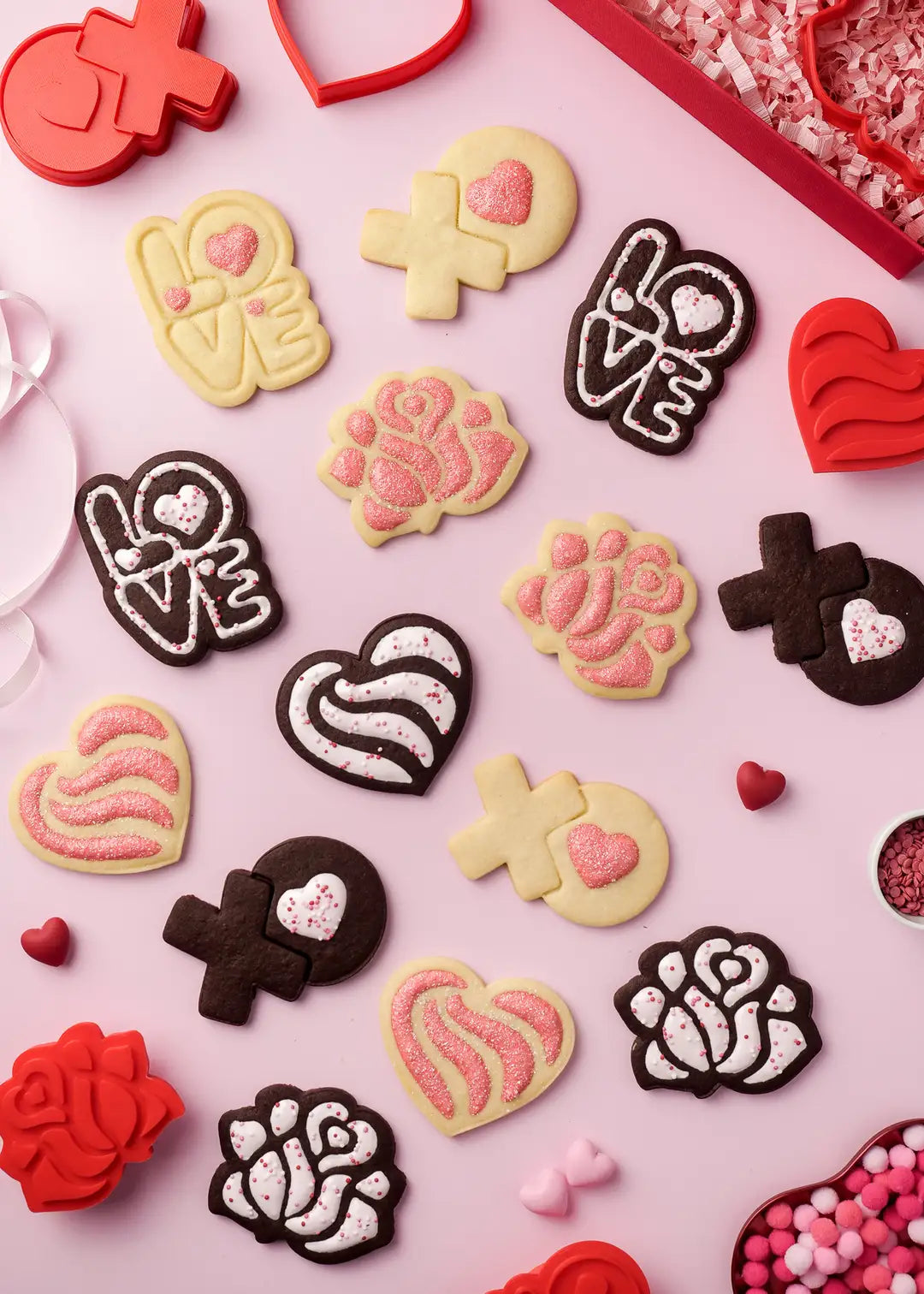 Romantic Valentine's Day cookies with love and heart designs – A beautifully arranged flat lay of Valentine's Day cookies featuring intricate details, hearts, roses, and the word "LOVE," all accented with pink sprinkles and icing for a sweet touch.