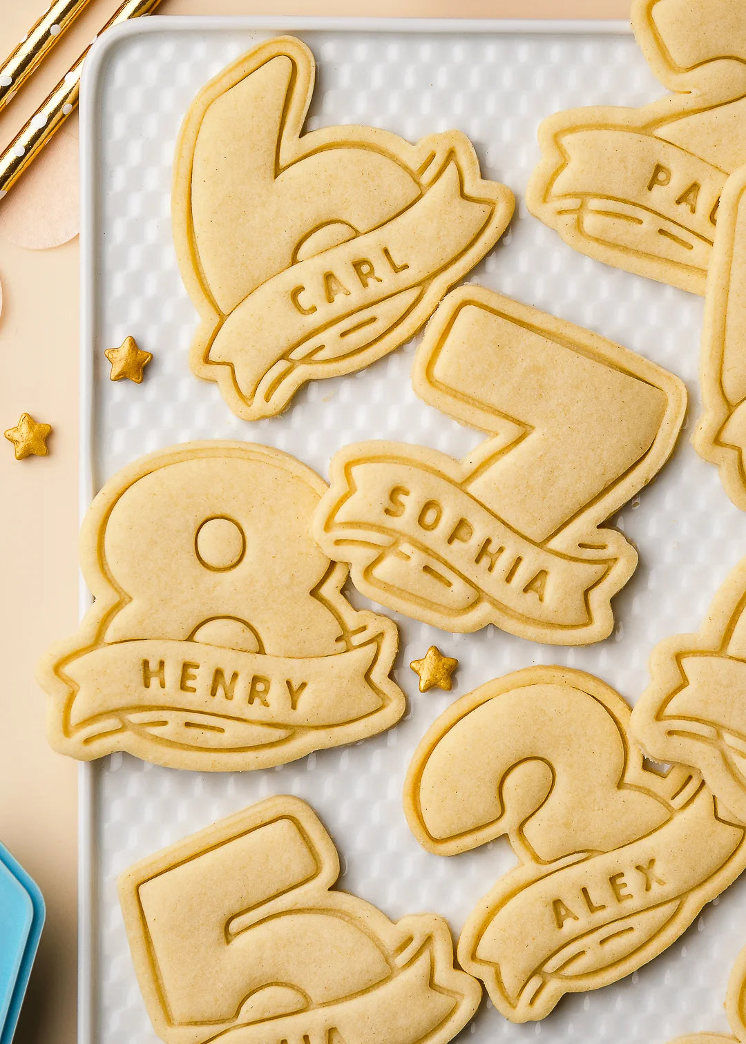 Close up of a set of number cookies from 0 to 9, each personalized with a name and beautifully arranged on a white tray. Made using custom 3D printed cookie cutters – perfect for kids’ birthday baking, party favors, or personalized treats.