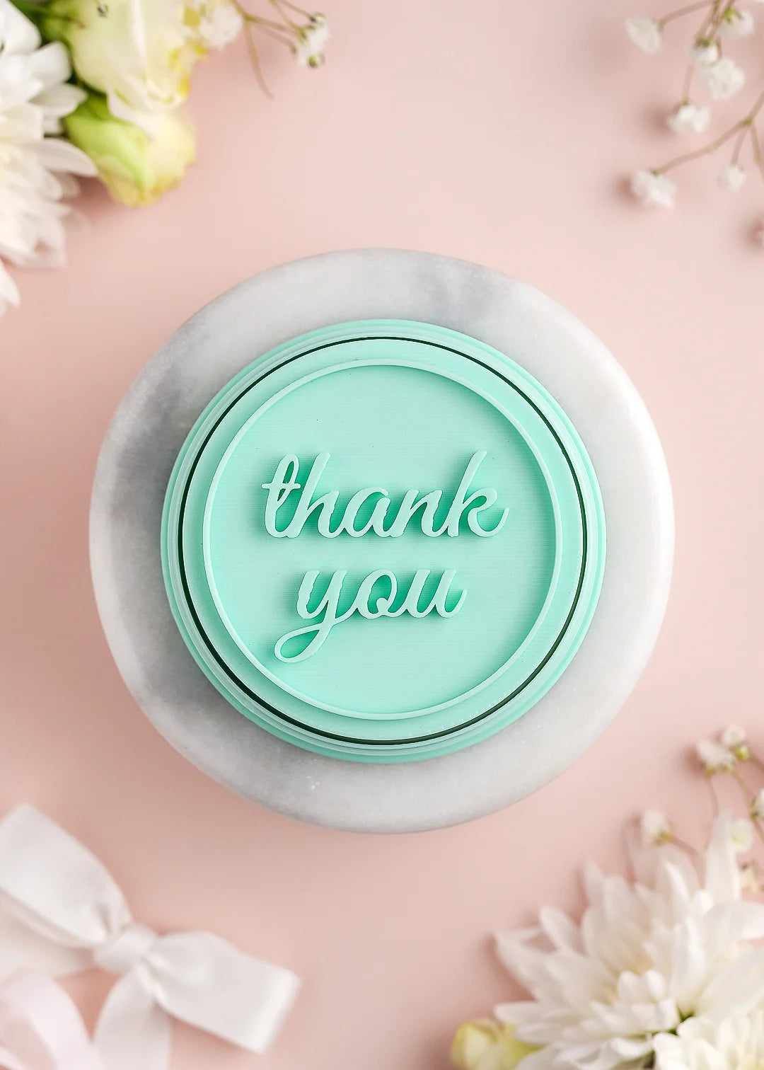 Round wedding cookie stamp with plain round border and custom text in cursive font. Example: "thank you"