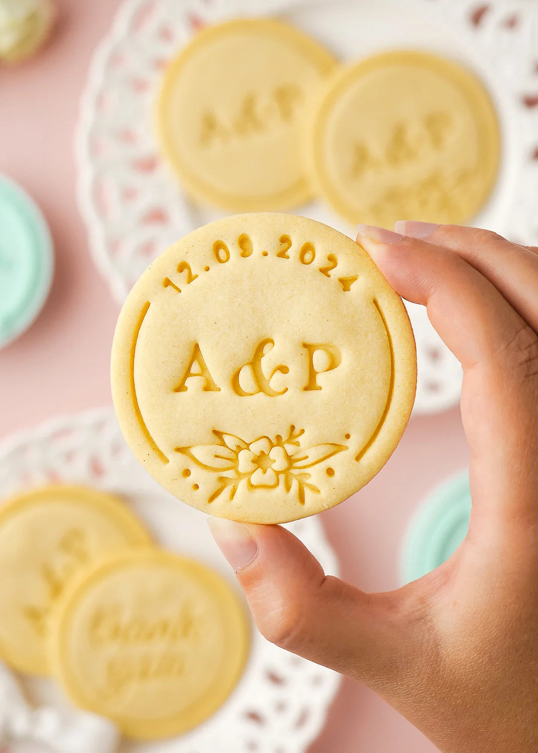 Baked cookie with initials A&P and date 12.09.2024, made with custom wedding round cookie stamp and a classic round cookie cutter.