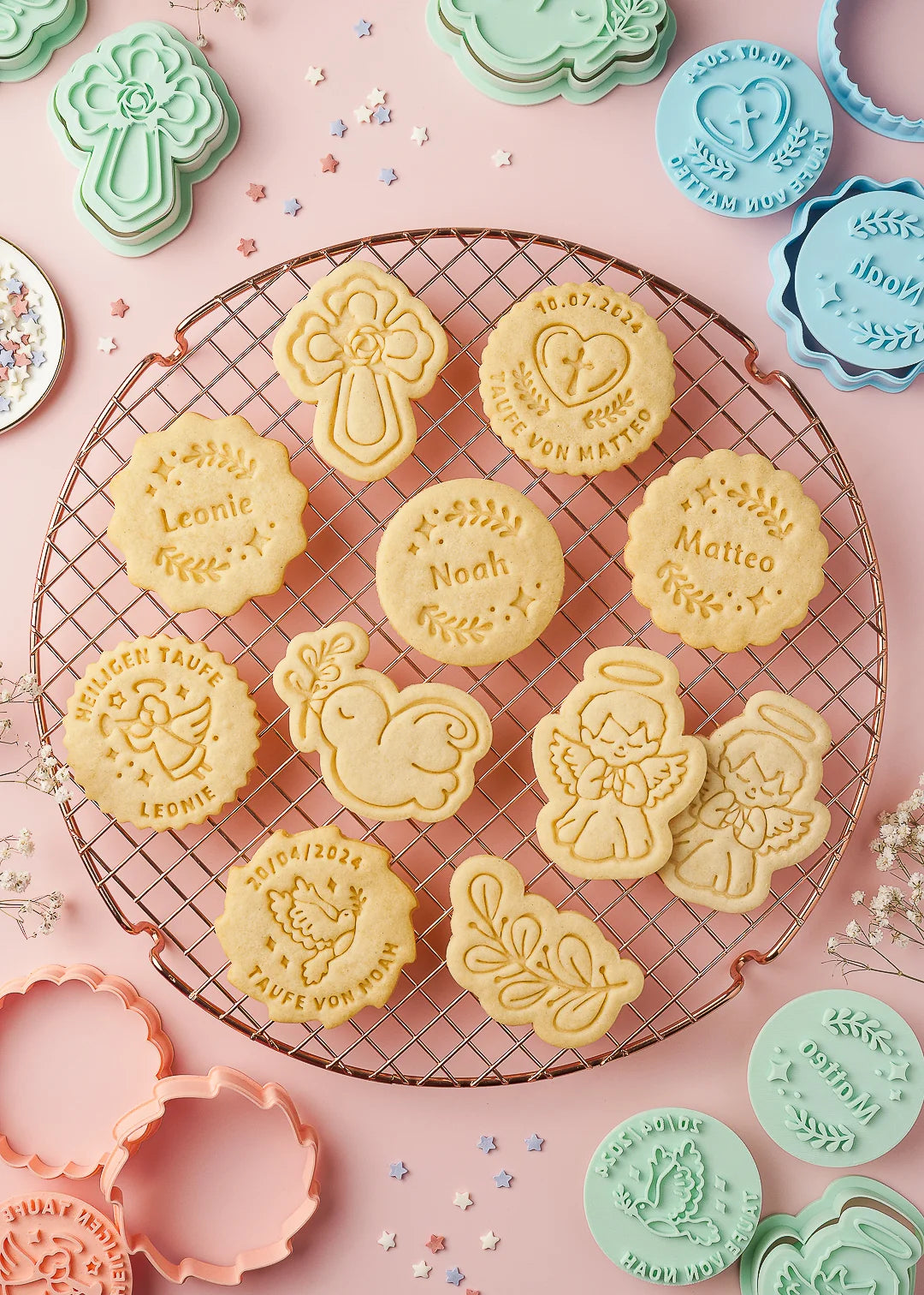 Baked cookies arranged on a cooling rack featuring our customizable designs and the cookie cutter set from our Baptism collection