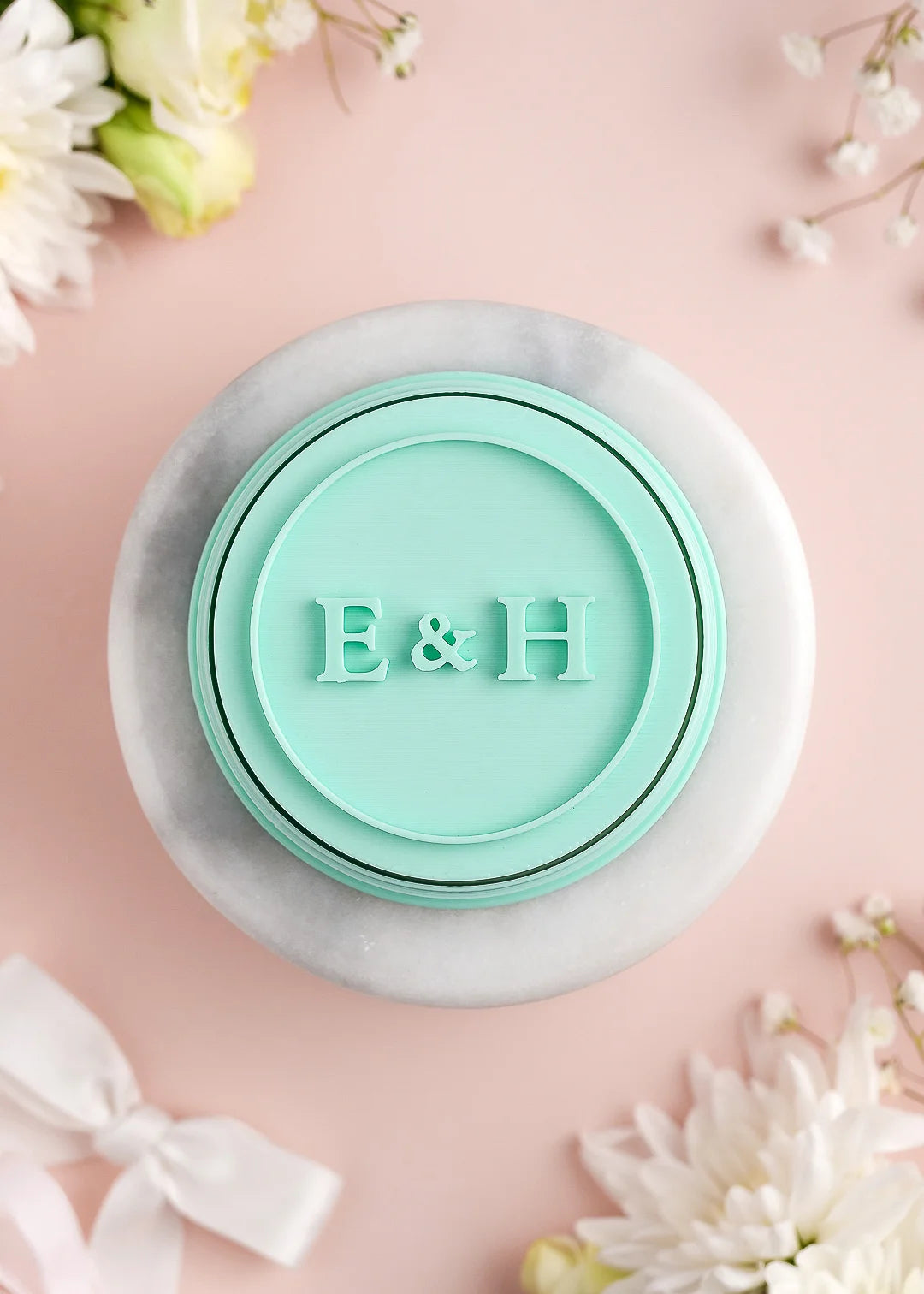 Round wedding cookie stamp with plain round border and custom initials. Example: E&H