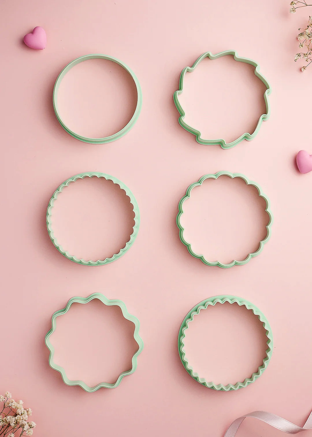Set of six mint green cookie cutters in various round edge styles – designed to perfectly match our cookie stamps. Includes classic round, scalloped, flower, wavy, sun and  star designs for beautiful cookie shapes.