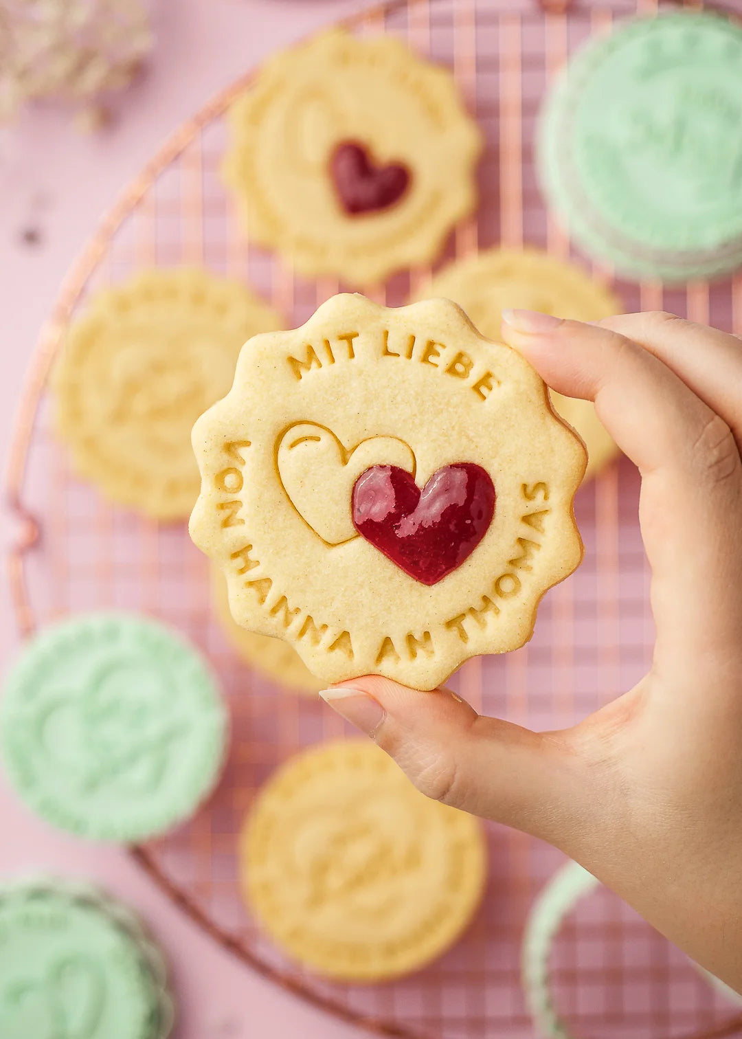 Personalized cookie stamped with “Mit Liebe – von Hanna an Thomas” and heart design, filled with red jam. Made using our custom cookie stamp – a perfect DIY gift idea for loved ones, anniversaries, or Valentine’s Day.