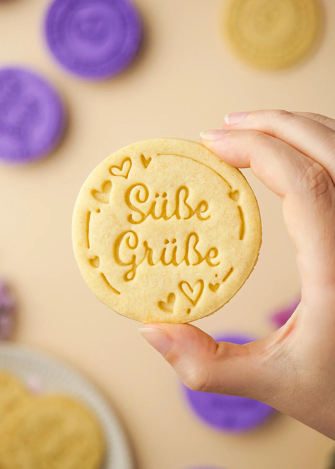 Close up of a perfectly shaped cookie made with our stamp collection. Message "Suesse Gruesse". Perfect for gift and for family.