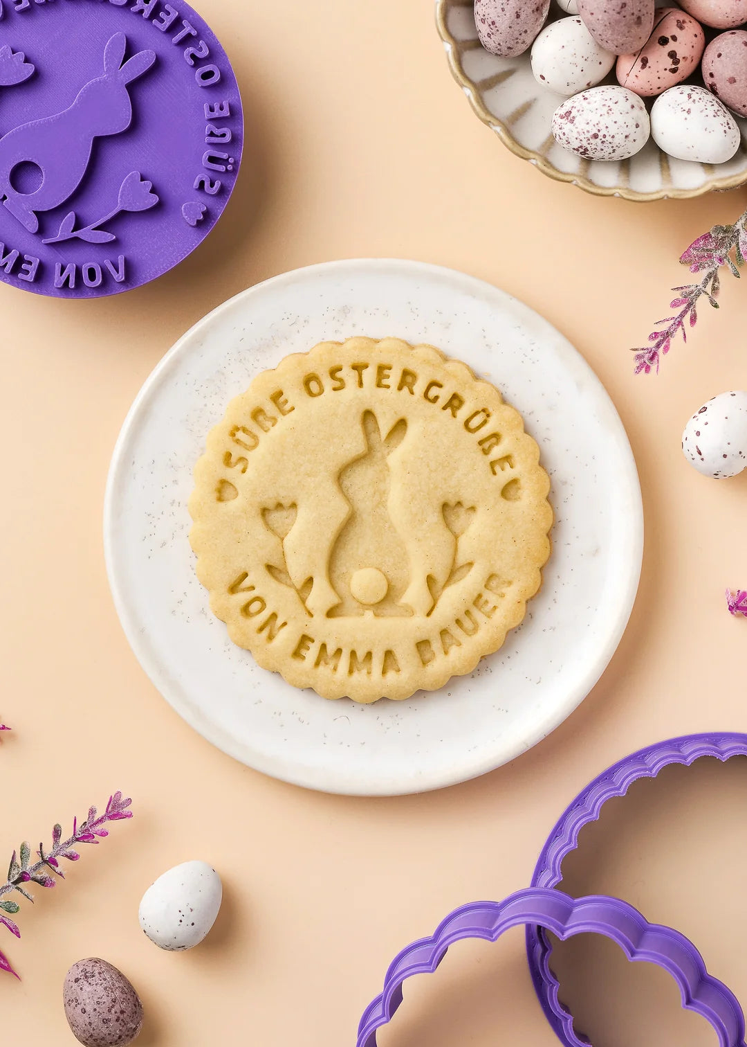 Baked cookie made with the custom stamp placed on a small plate