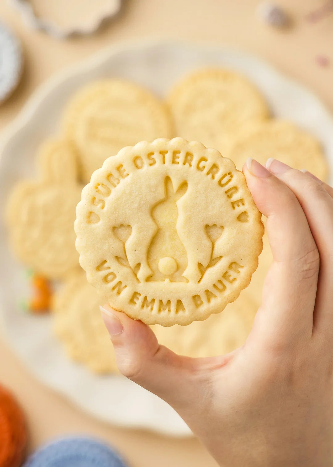 Hand holding the baked cookie made with the custom stamp