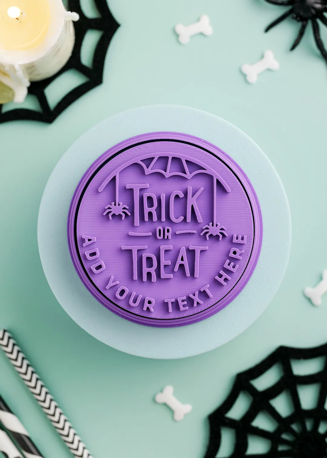 Purple 'Trick or Treat' stamp on a green background with Halloween decorations.