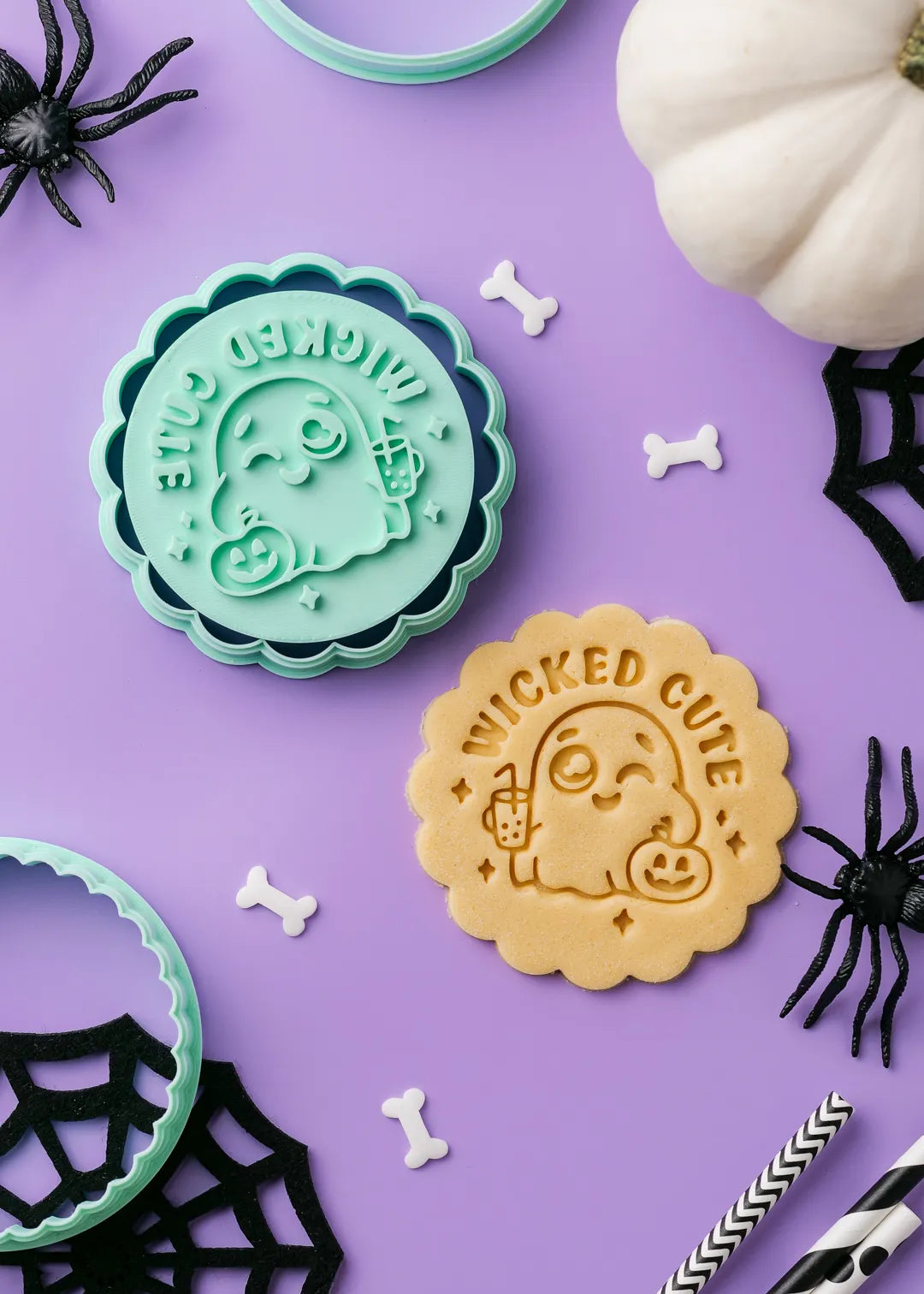 Halloween-themed cookie stamp with cute ghost design and "wicked cute" text on a purple background with decorative festive elements.