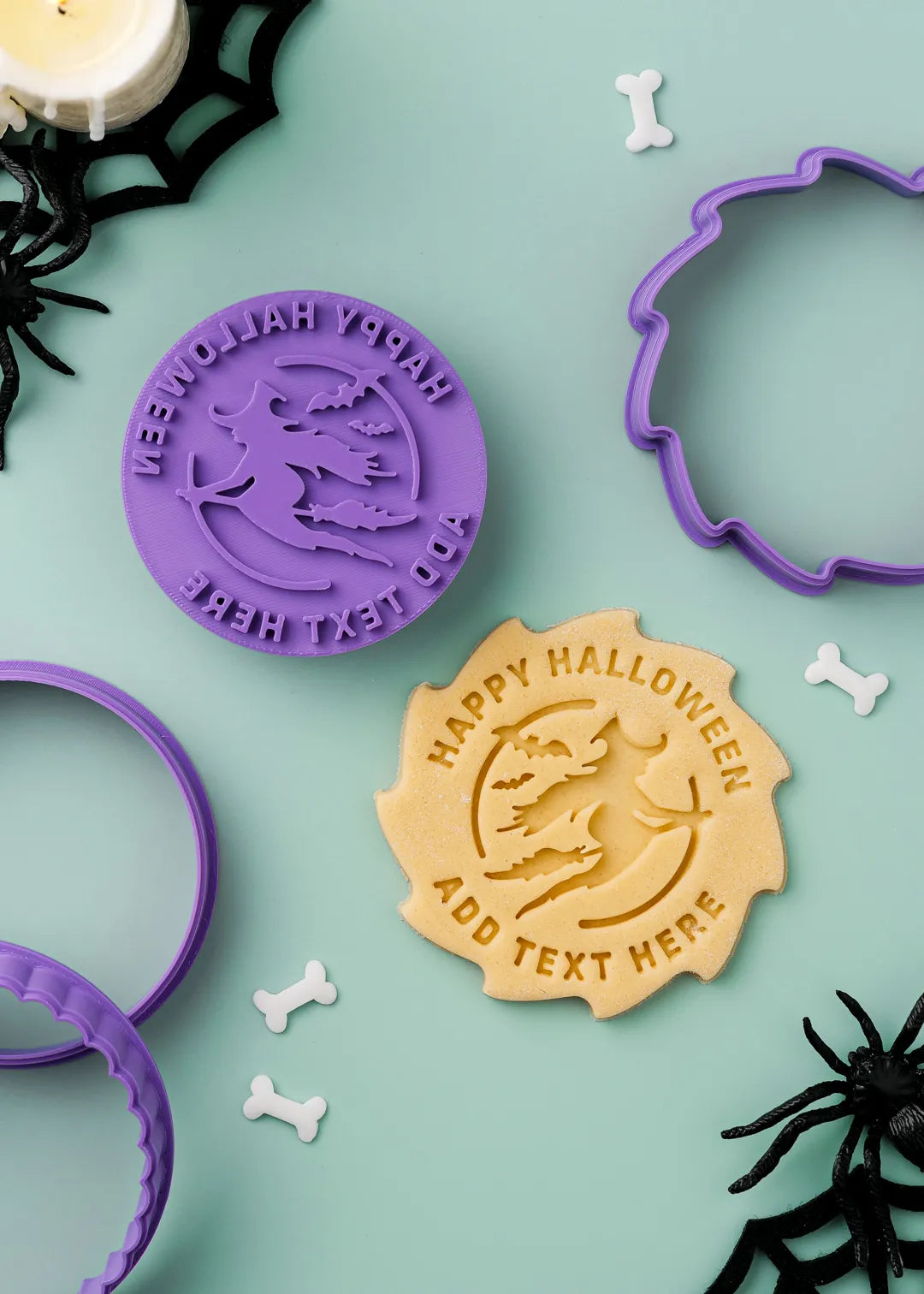 Personalized Halloween-themed cookie stamp with a witch design and option to add custom text around it, with cookie made with the stamp on a green background.