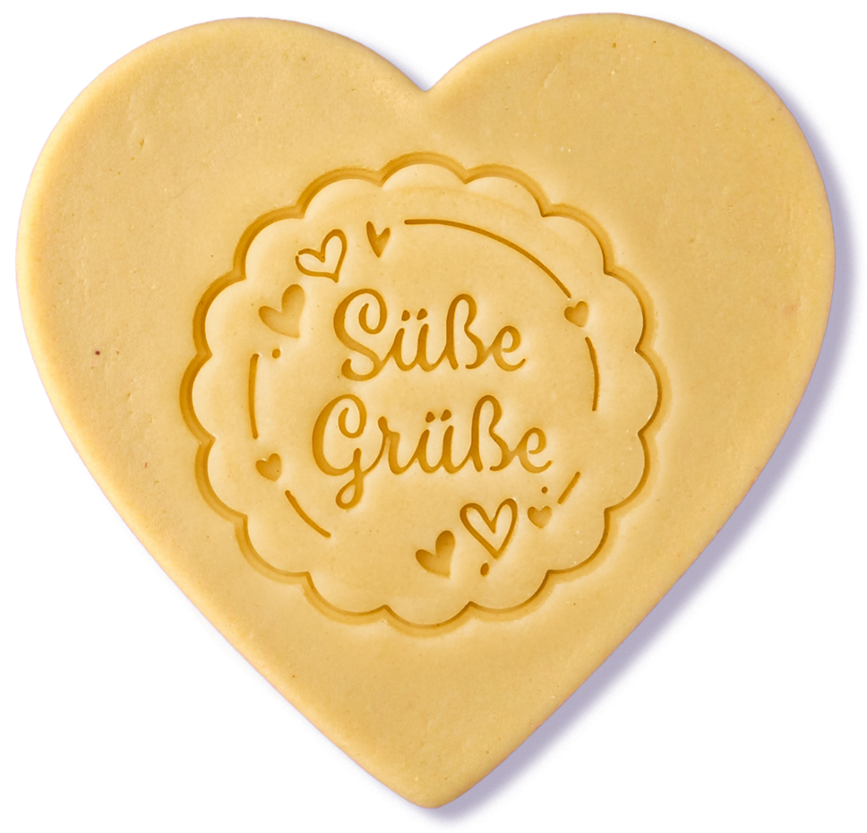 heart-shaped sugar cookie dough with a scalloped cookie stamped in the middle of it saying "Süße Grüße" with little hearts around it