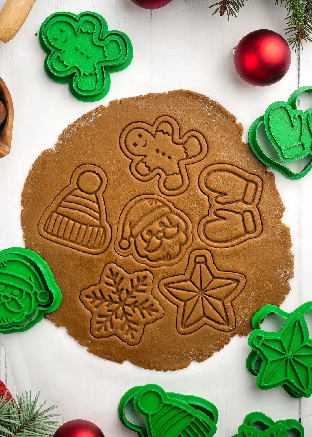 close up photo of cookie stamps pressed onto rolled out gingerbread dough; perfect imprints and clean cuts